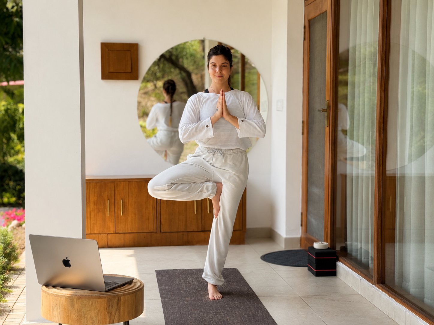 Practicing yoga from home with laptop